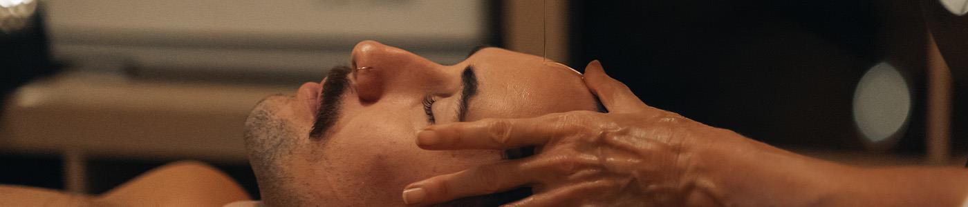 oil being poured over mans head