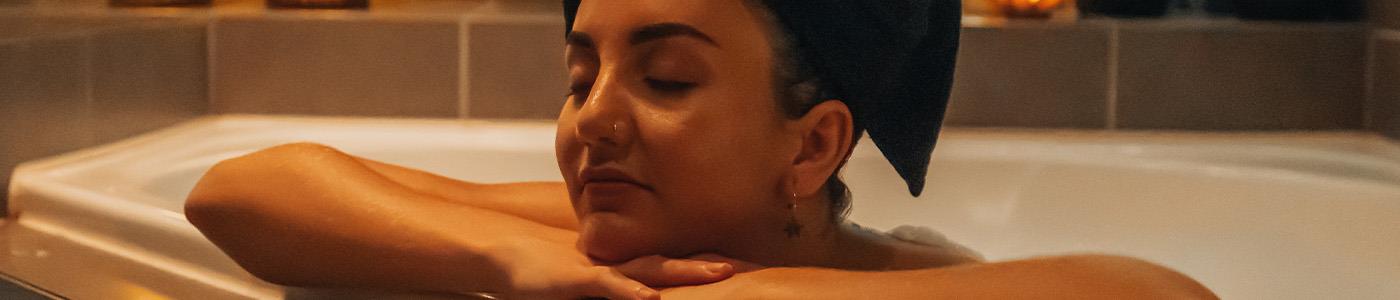 spa bath with small platter of food next to it