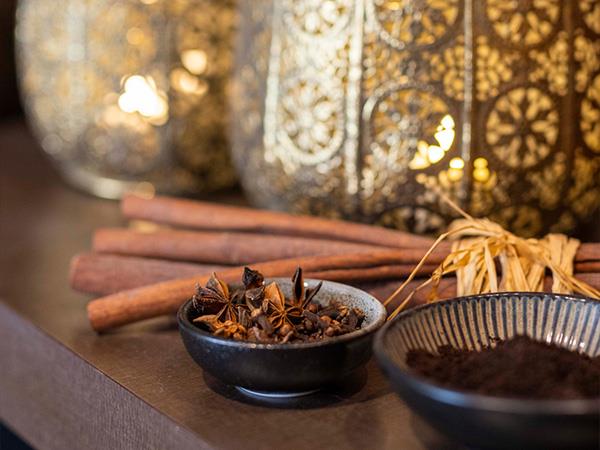 Day spa setting of bowls of spice and glowing lanterns